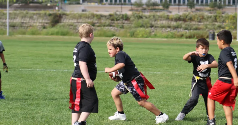 Kids playing flag football outside